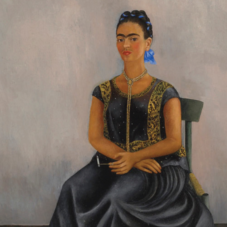 1938 self-portrait of Frida Kahlo seated in a straw chair wearing a huipil (or tunic) smoking a cannabis cigarette, with a hairless dog at her feet.