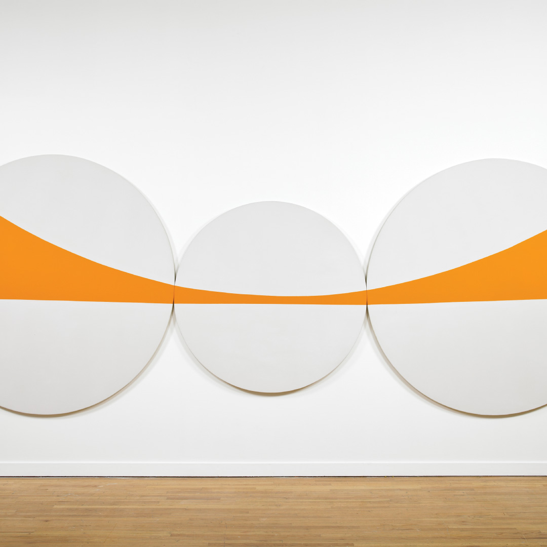 Three circular canvases with a stripe of orange across them
