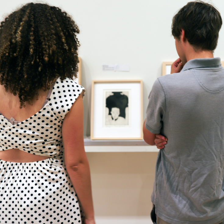 Two students looking at art in the Lee Gallery