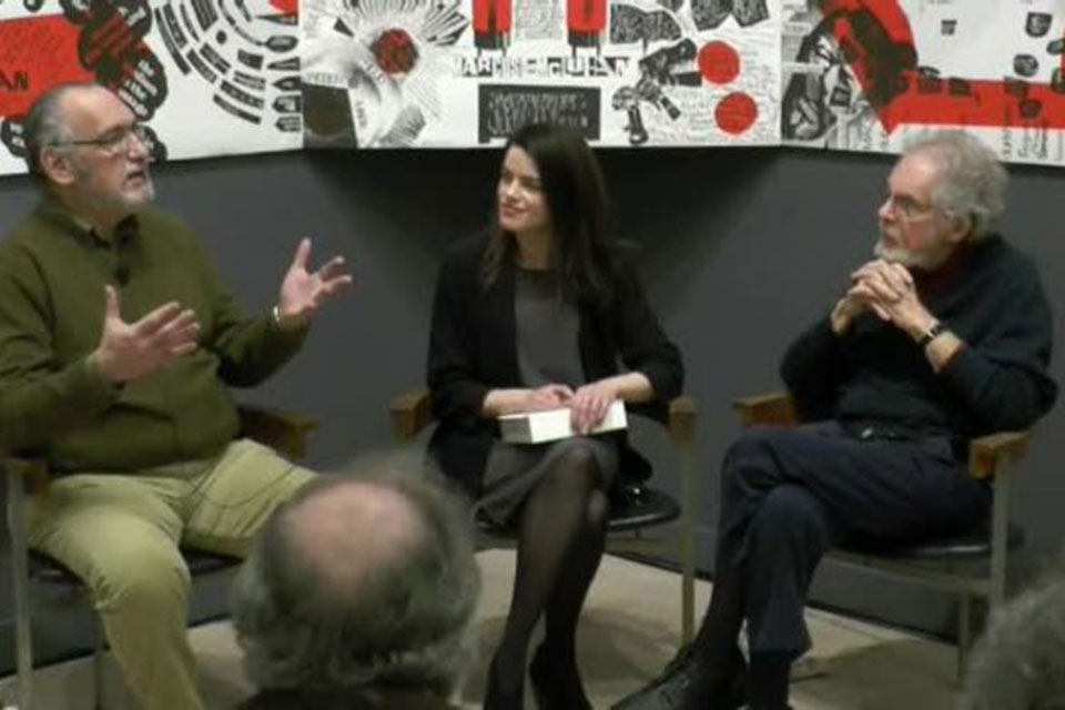 Three people sitting in chairs having a discussion.