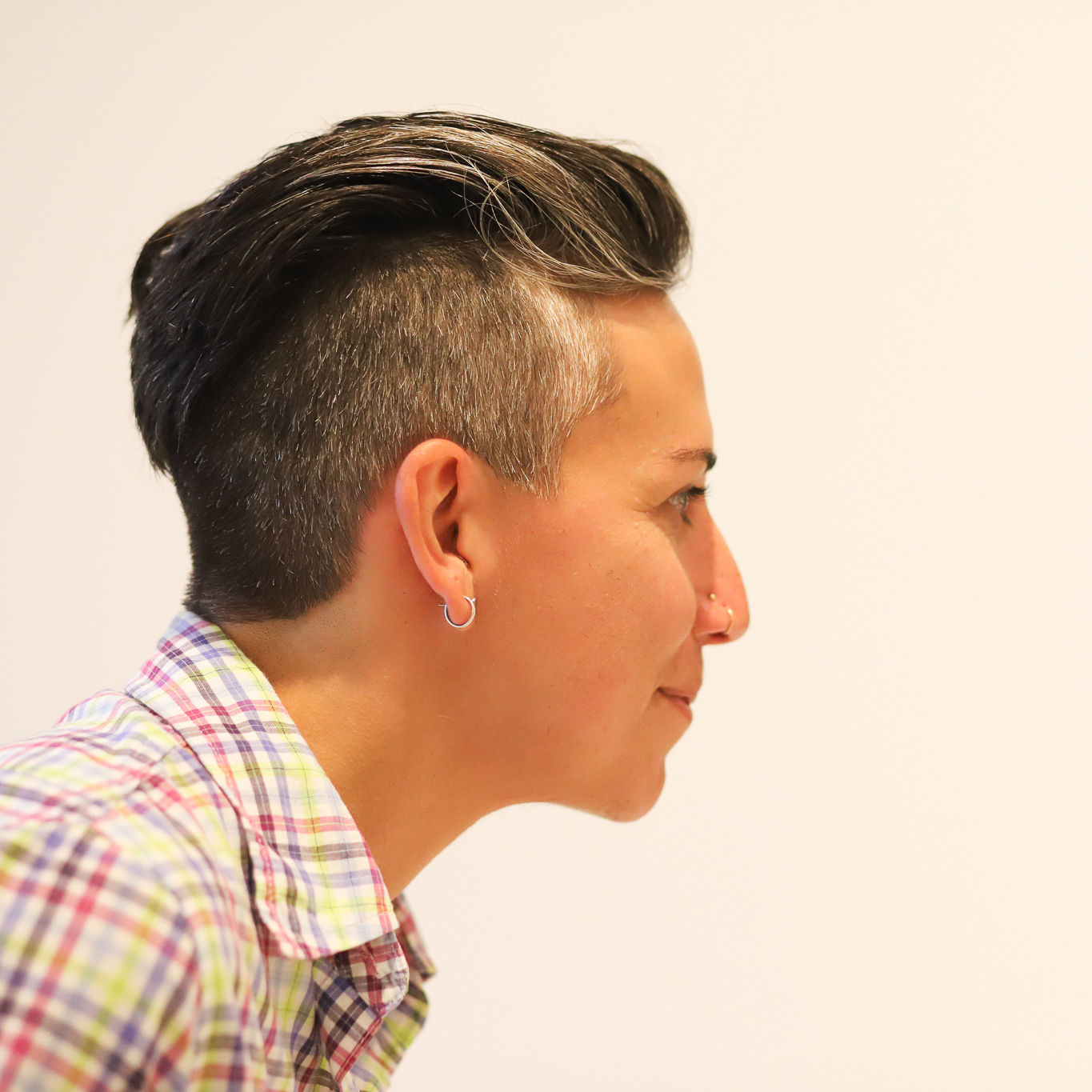 Person in galleries looking closely at an unseen work of art