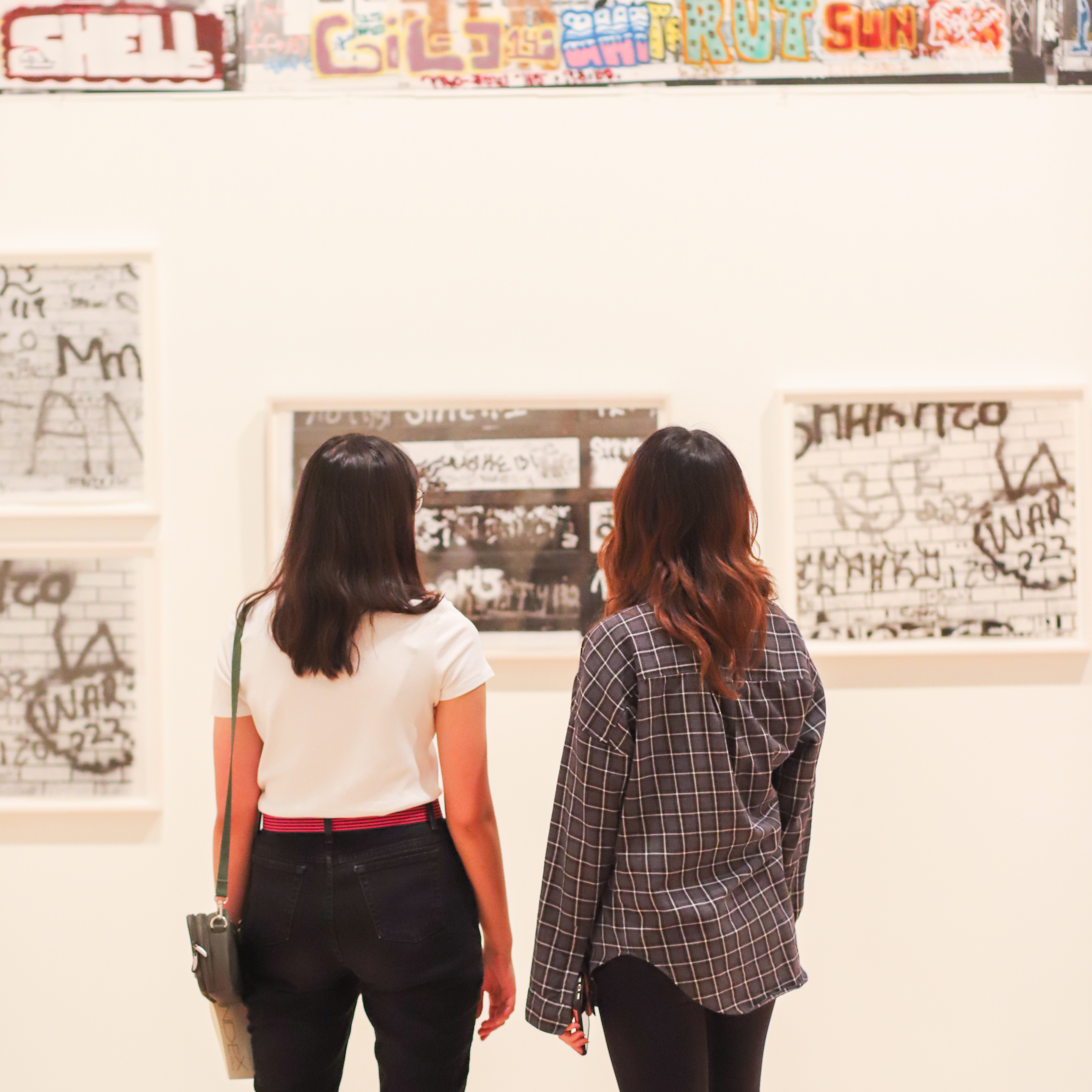 Two students looking at photographs of graffiti
