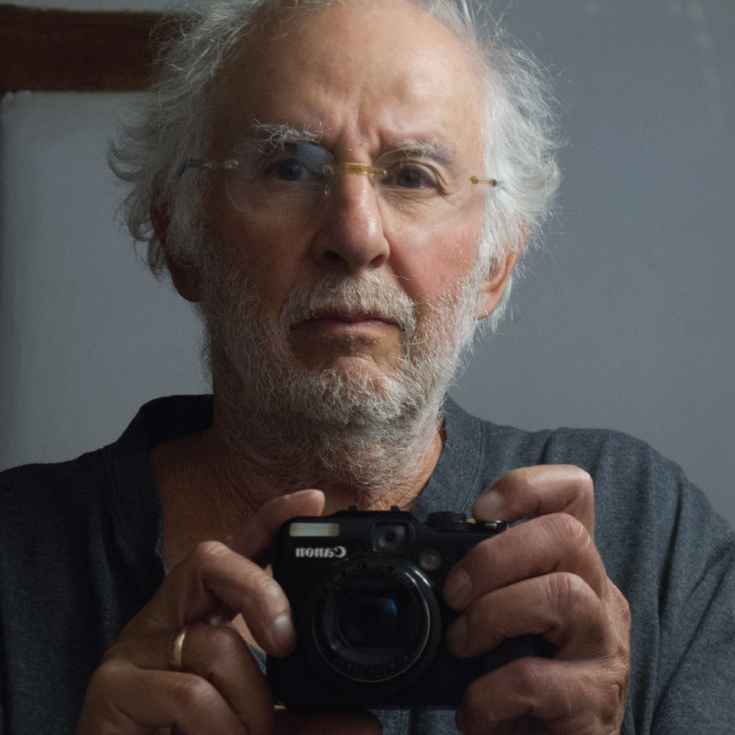 Self portrait of Danny Lyon holding a camera