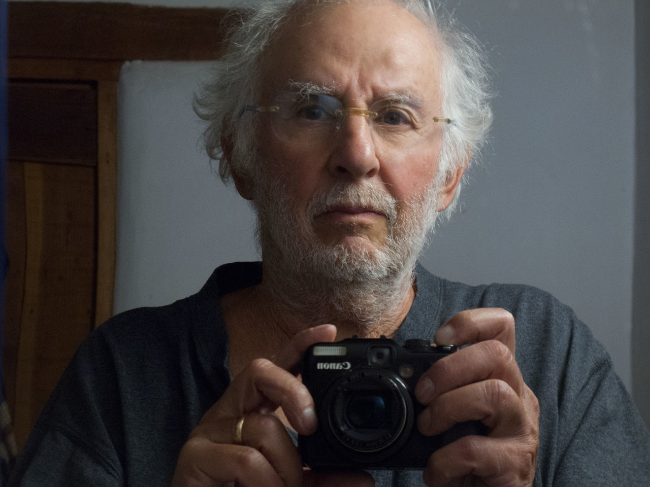 Self portrait of Danny Lyon holding a camera