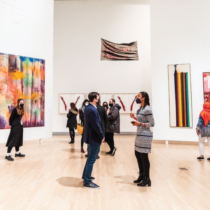 Groups of people talking and looking at art in the Rose Art Museum