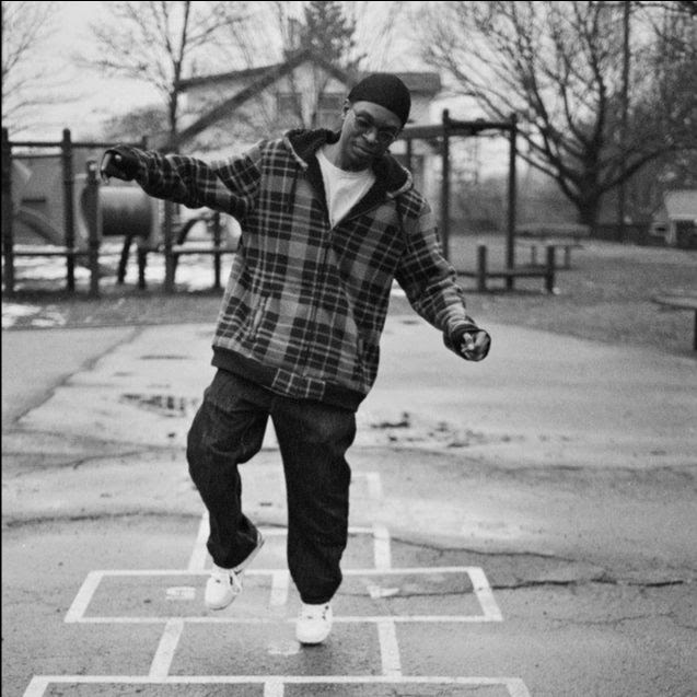 A black man playing hop-sotch