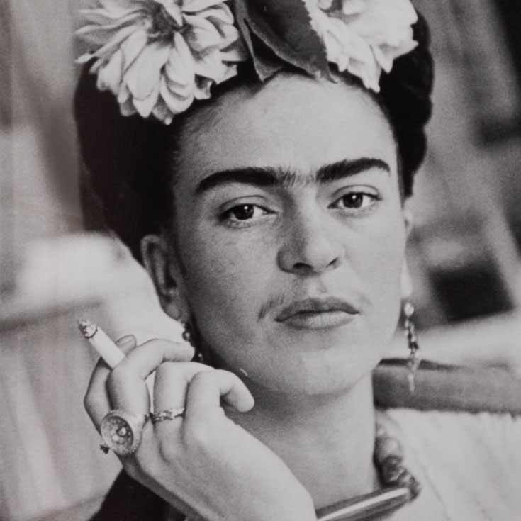 Frida Kahlo holding a cigarette. 