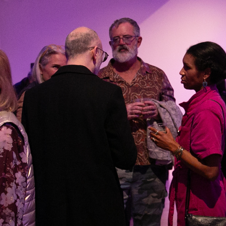 People talking in the Lee Gallery of the Rose Art Museum.