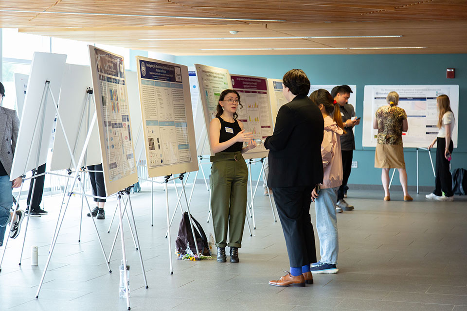A student discussing research at SciFest.