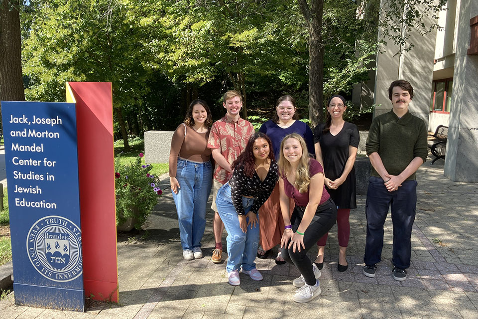 6 students and Professor Ziva Hassenfeld standing in a group