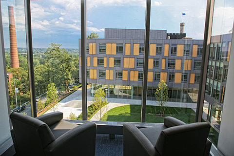 Two chairs positioned at the windows on an upper floor of Skyline Residence Hall