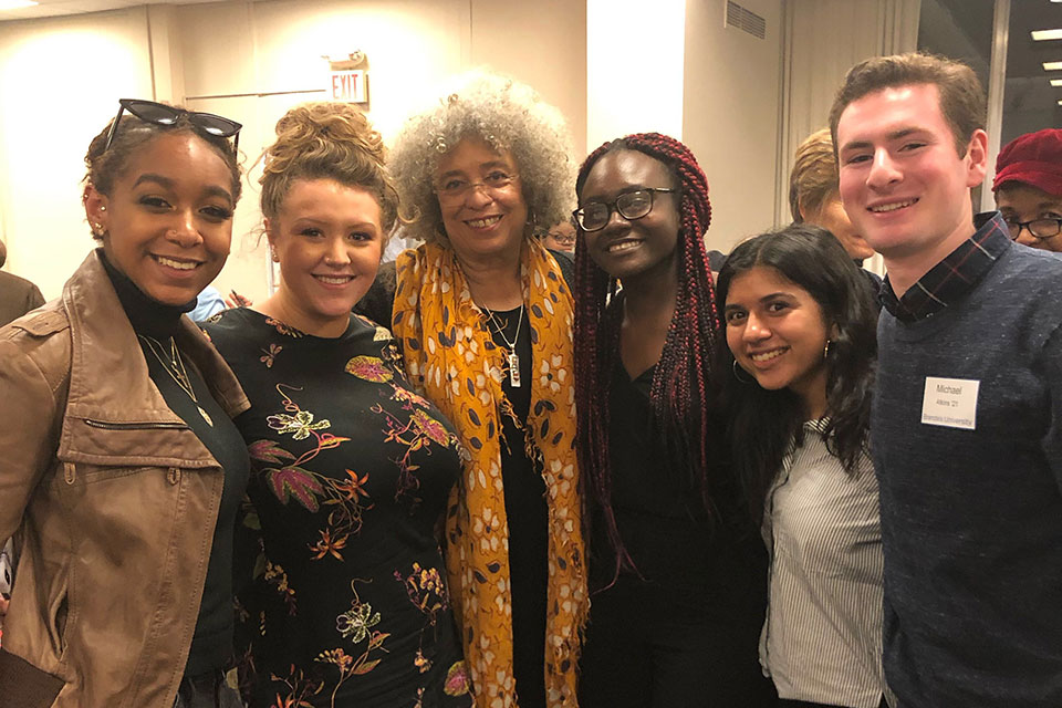 A group of students stand with Angela Davis