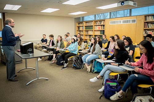 Professor Rosenberger teaching a class of students sitting at desks.