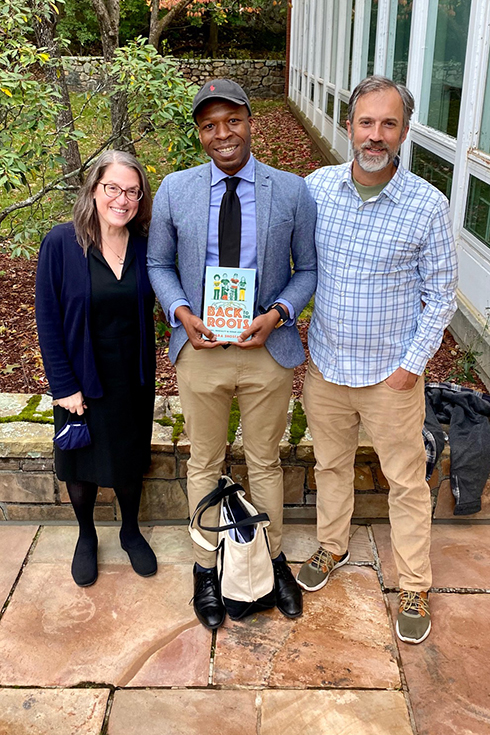 Sara Shostak, Norris Guscott, and J. Harrison standing together outside.