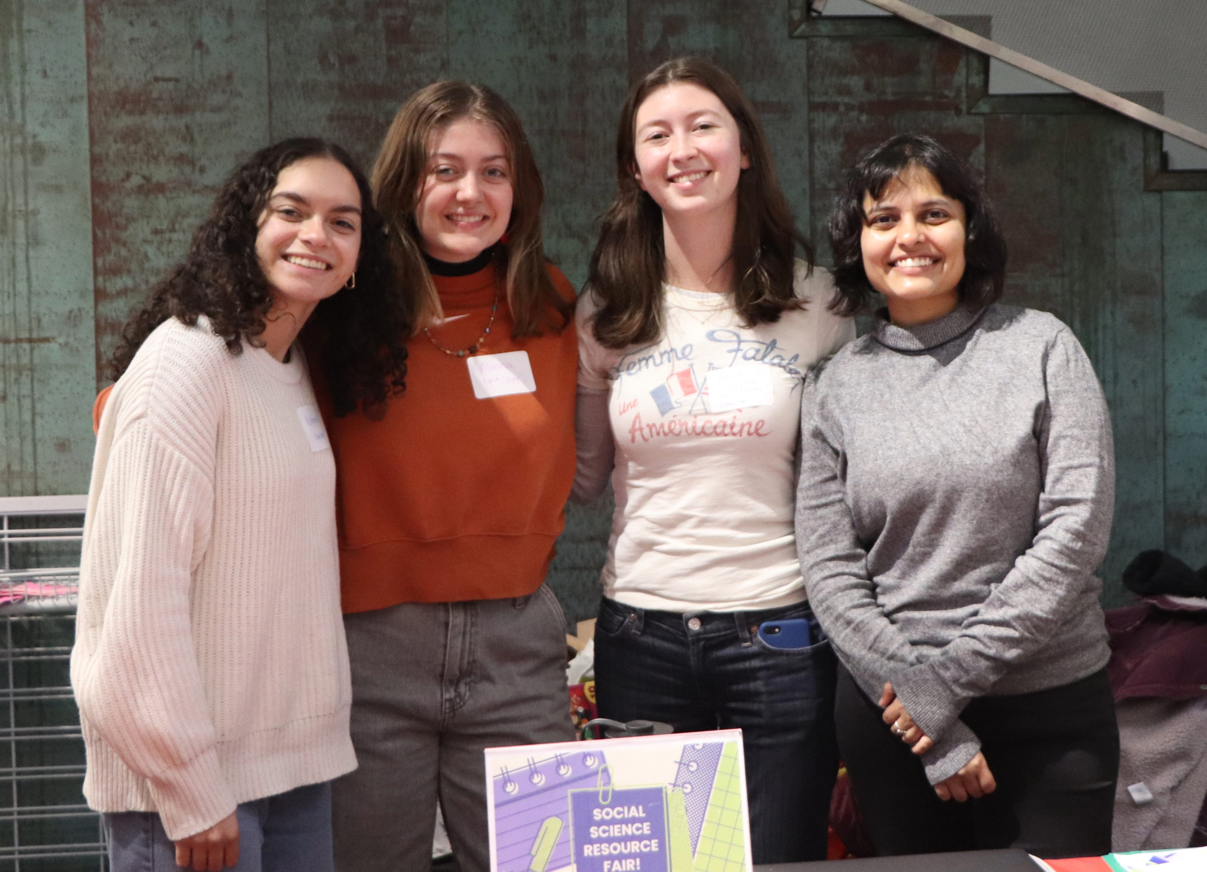 Three UDRS and Grad student take picutre at social science fair 