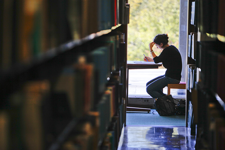 Student sitting in the library at table