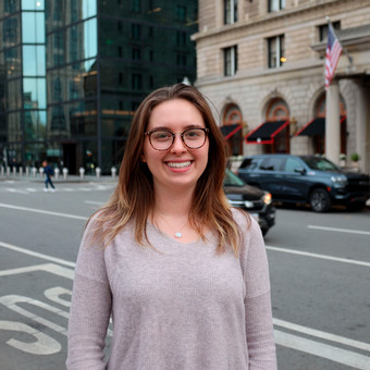 photo of top half of Emma Neuner's body on what appears to be a New York City street