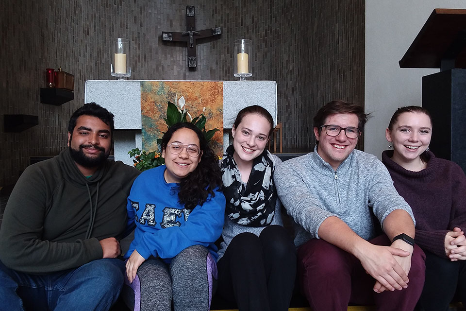  5 students sitting together in chapel