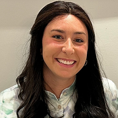 a headshot of a woman with dark straight hair