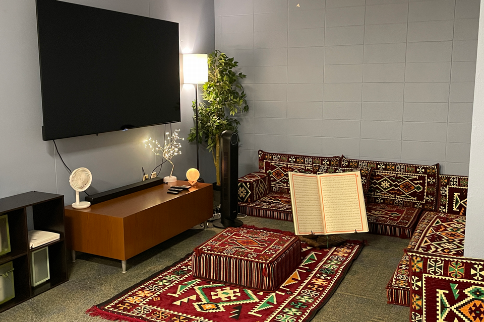 Muslim prayer room with oriental rugs on ground