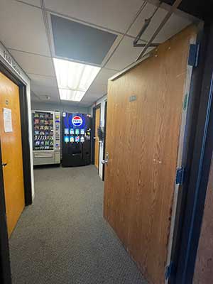 Walking through a door looking at vending machine
