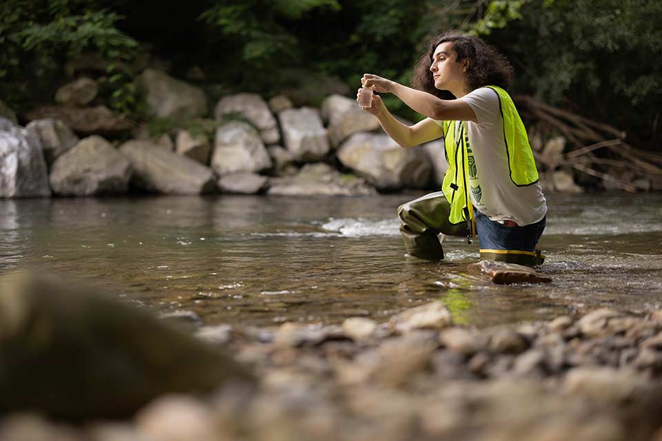 Lucas Forman conducting a test in a river.