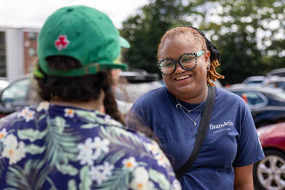 Two people chatting in the parking lot during move-in