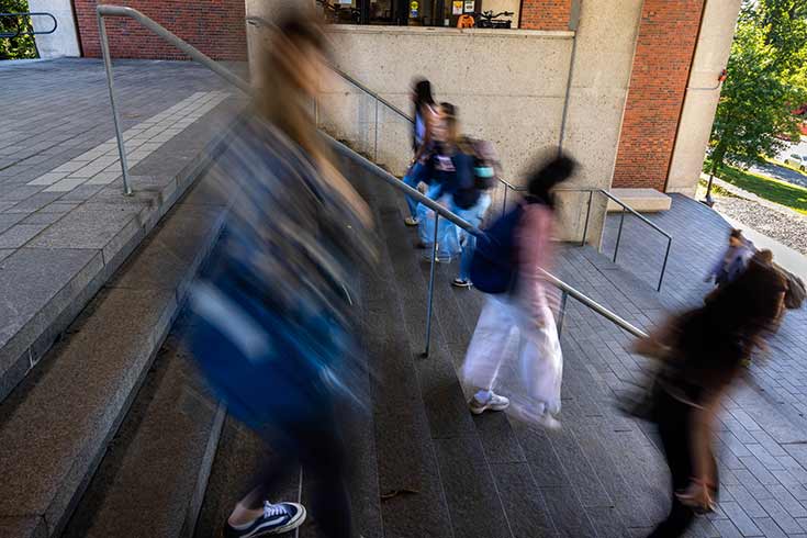 Students walking down steps, their images blurred