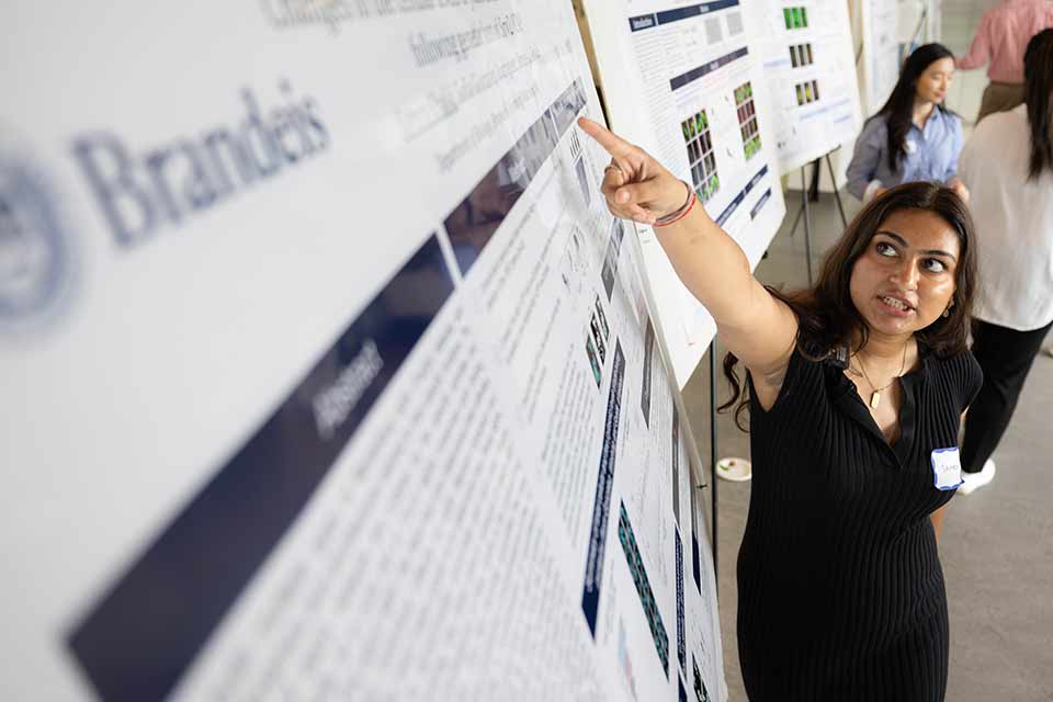 Samra Khalid points to her research poster during Scifest