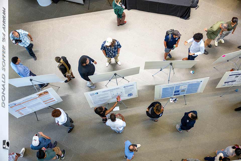 Students engaging with posters at SciFest