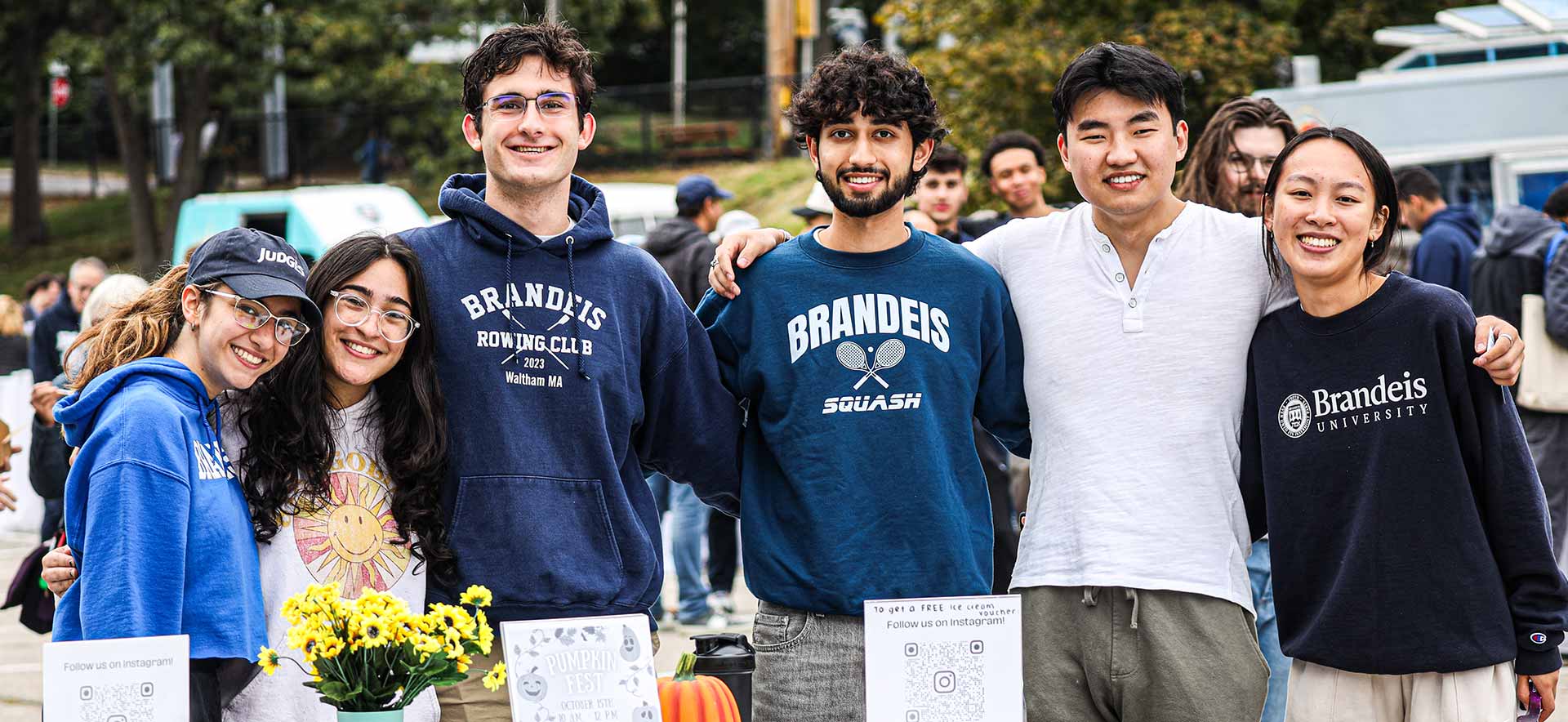 Two people wearing Brandeis sweatshirts and smiling