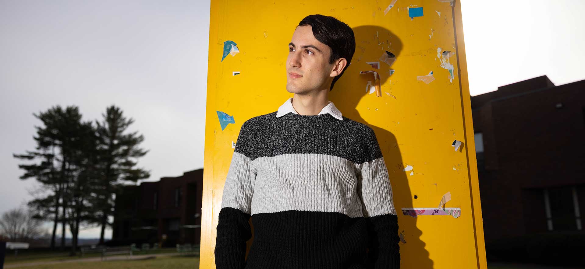 Cameron Samuels stands in front of a yellow post