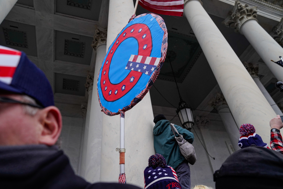 A QAnon sign is displayed during the riot at the Capitol.