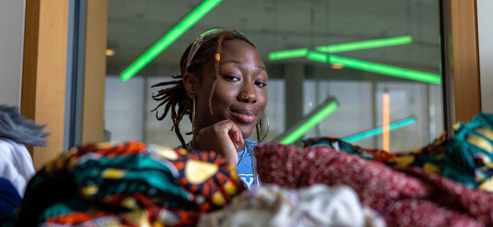 Mazzi Ingram poses with a pile of clothing.