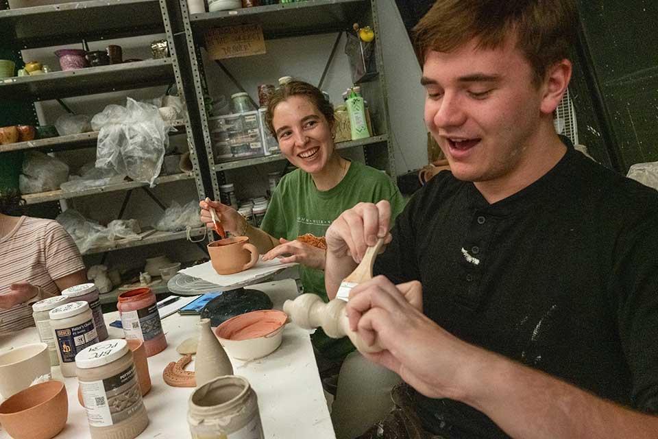 Students glaze their pottery