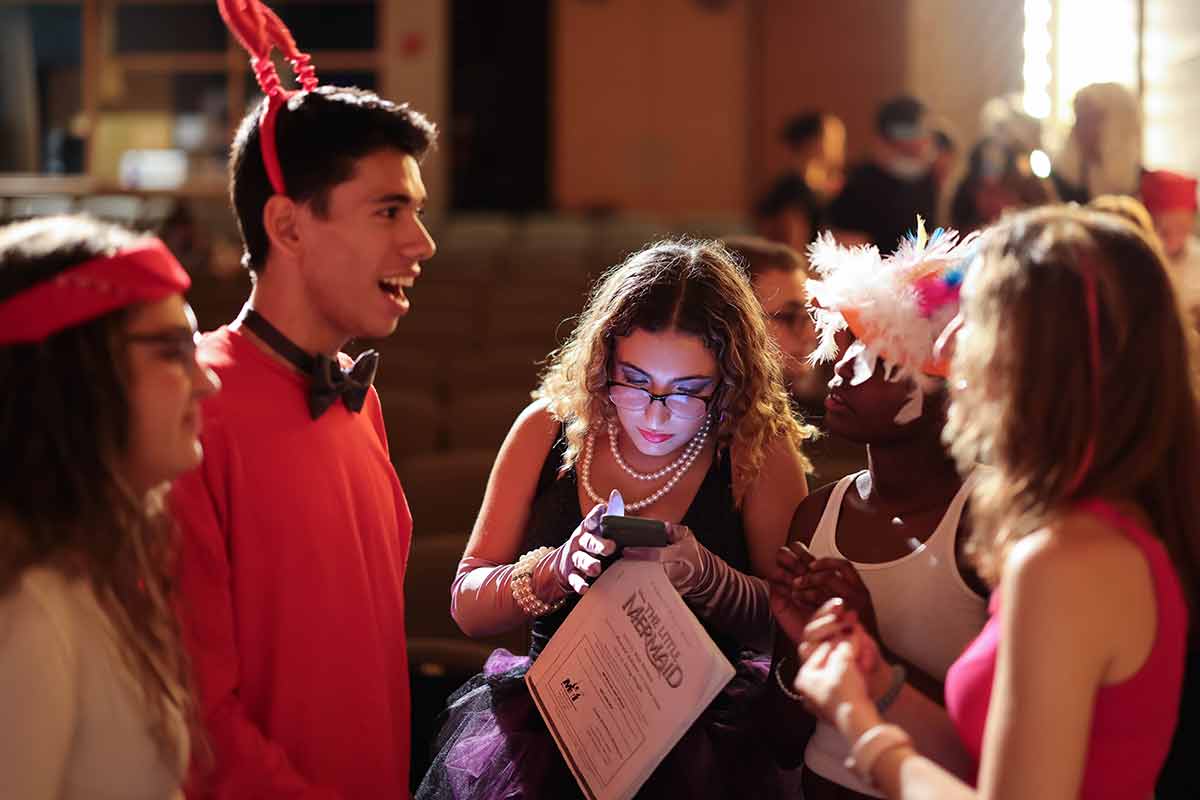 People dressed in red preparing for stage