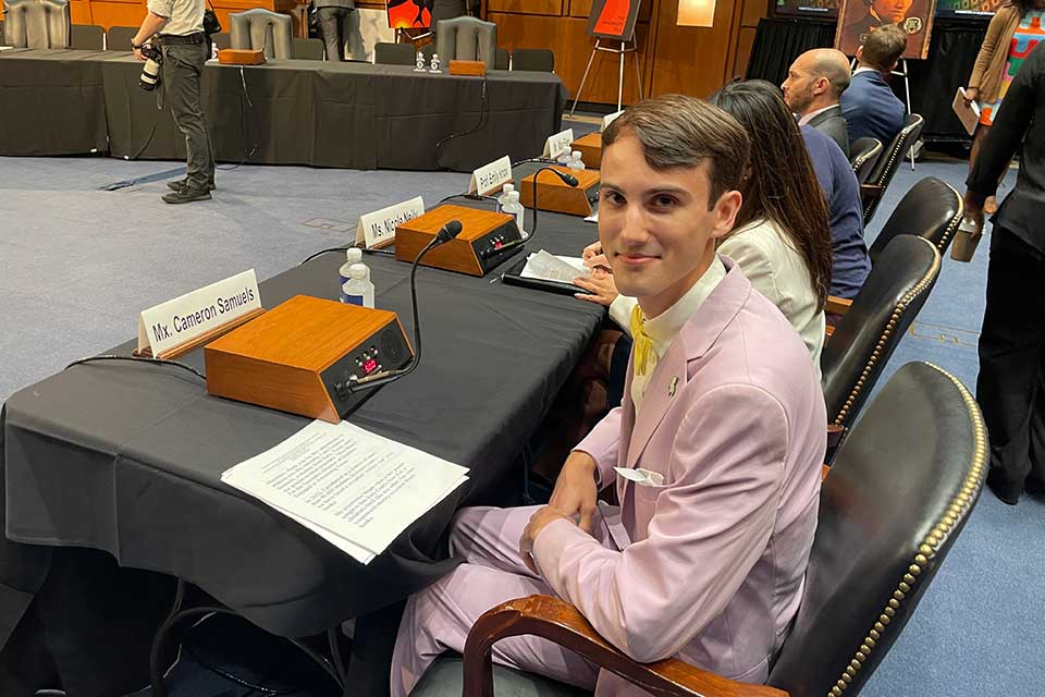 Cameron Samuels sits at a table ready to testify before the Senate