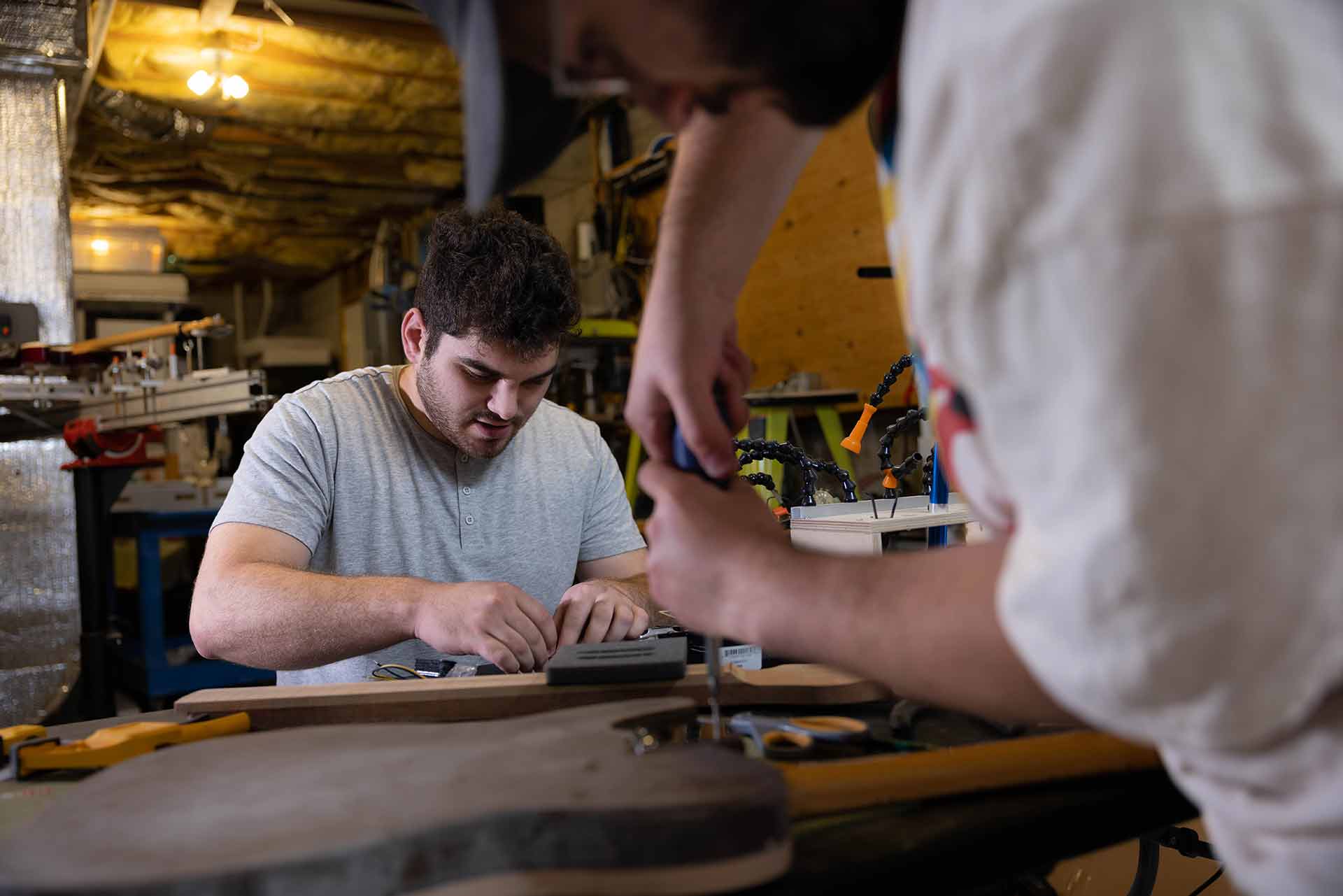 Alden Kennedy works with Sam at a tool bench