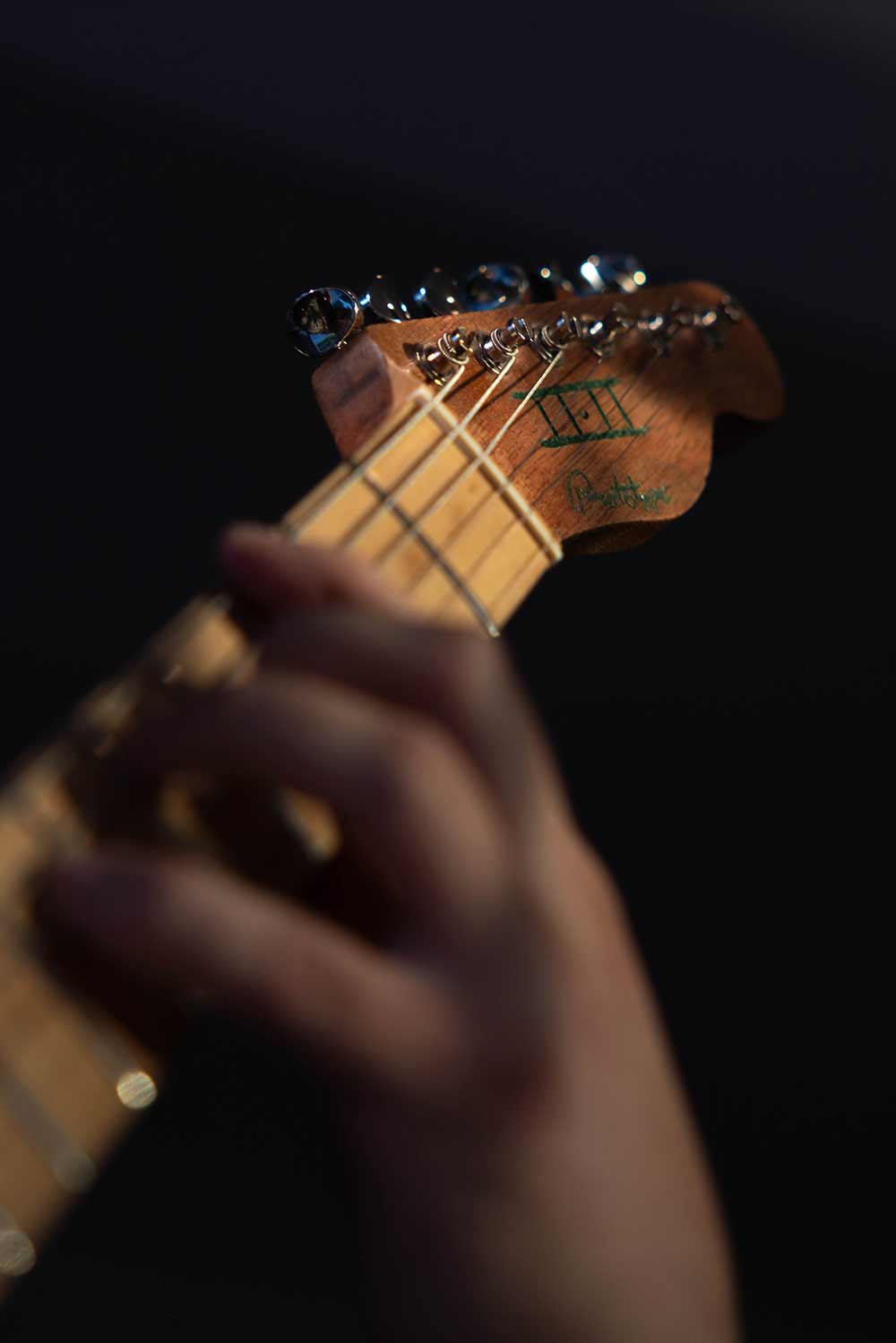 A hand on guitar frets