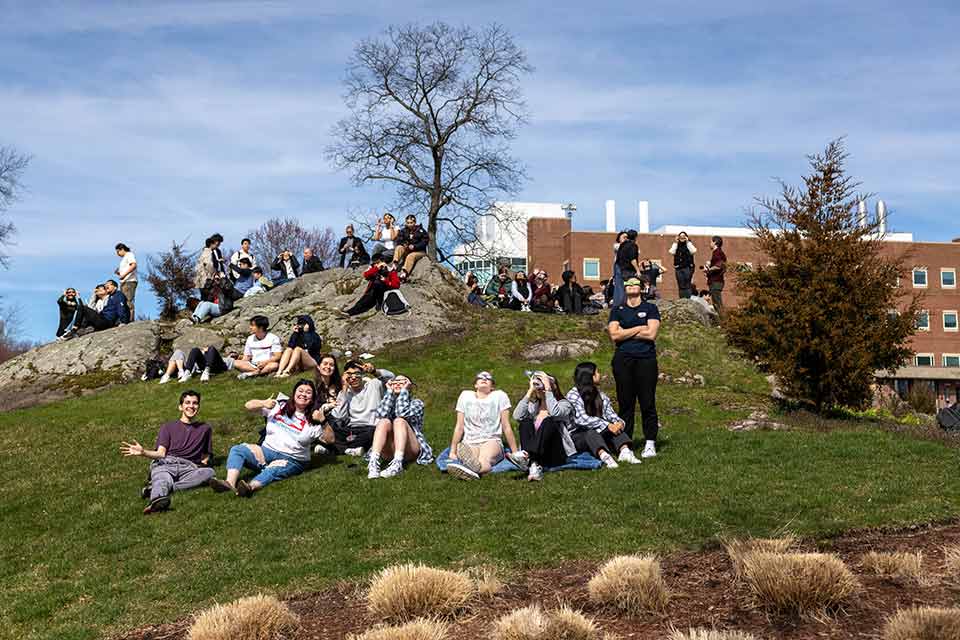 Fellows garden filled with people smiling and enjoying the eclipse