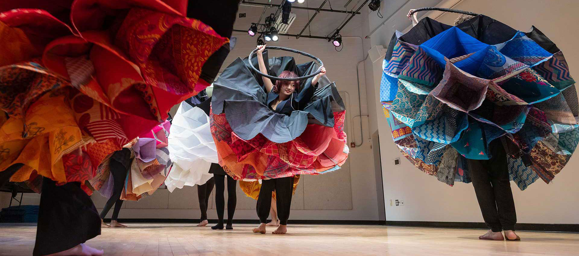 Dancers in Springold Theater dressed in bright costumes.