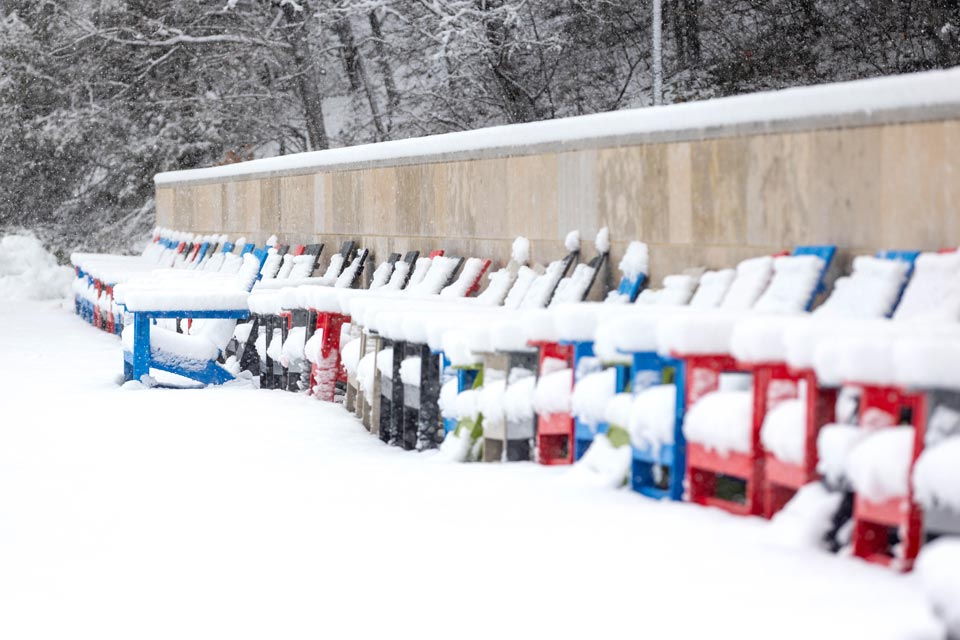 Colorful chairs covered with snow