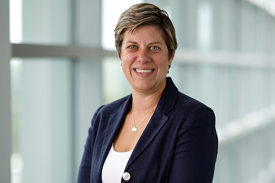 A photograph of Jessica Chapin smiling, in a suit coat.