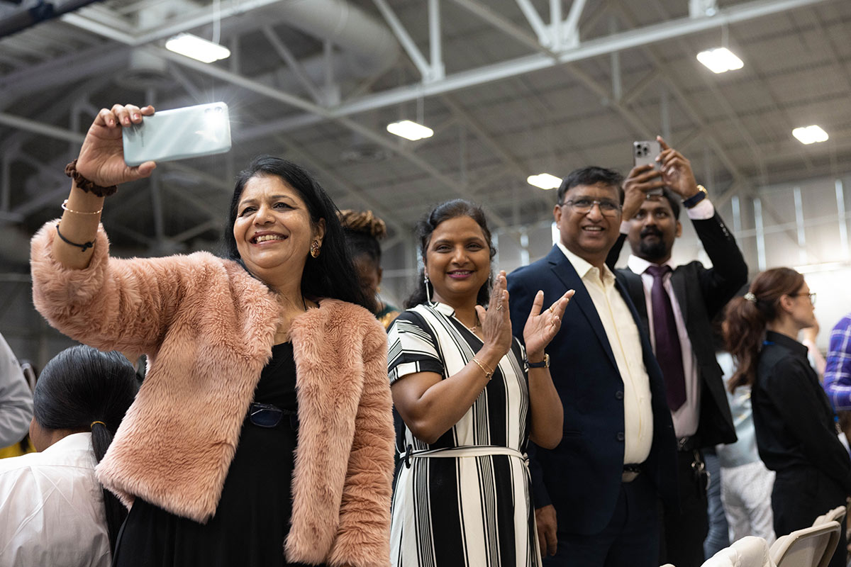 People with cameras taking photos and smiling