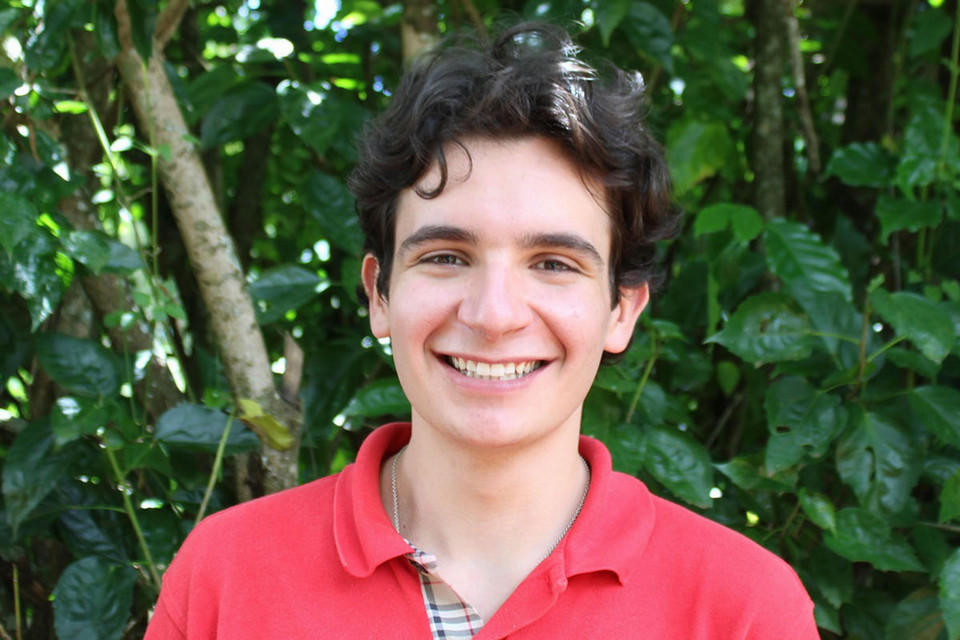 Daniel Block smiling in front of a leafy green background