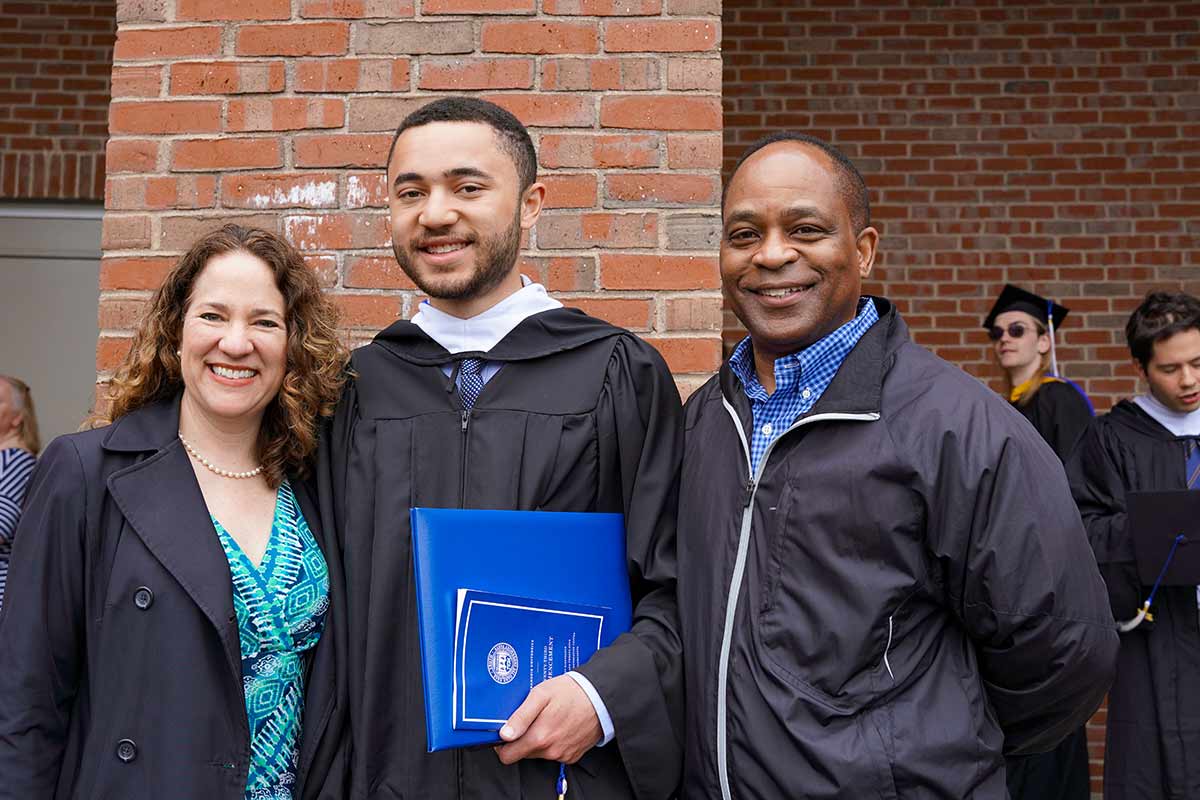 A graduate with his parents