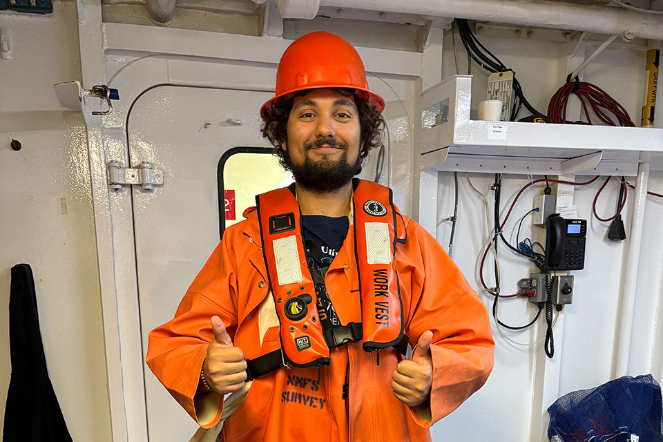 Greg dressed in bright orange research gear.