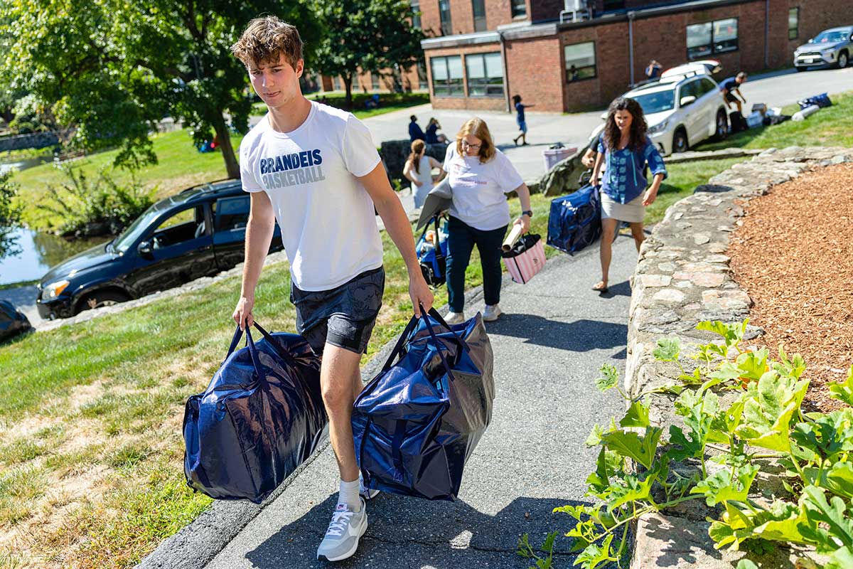 Asher White carries two large bags on campus.