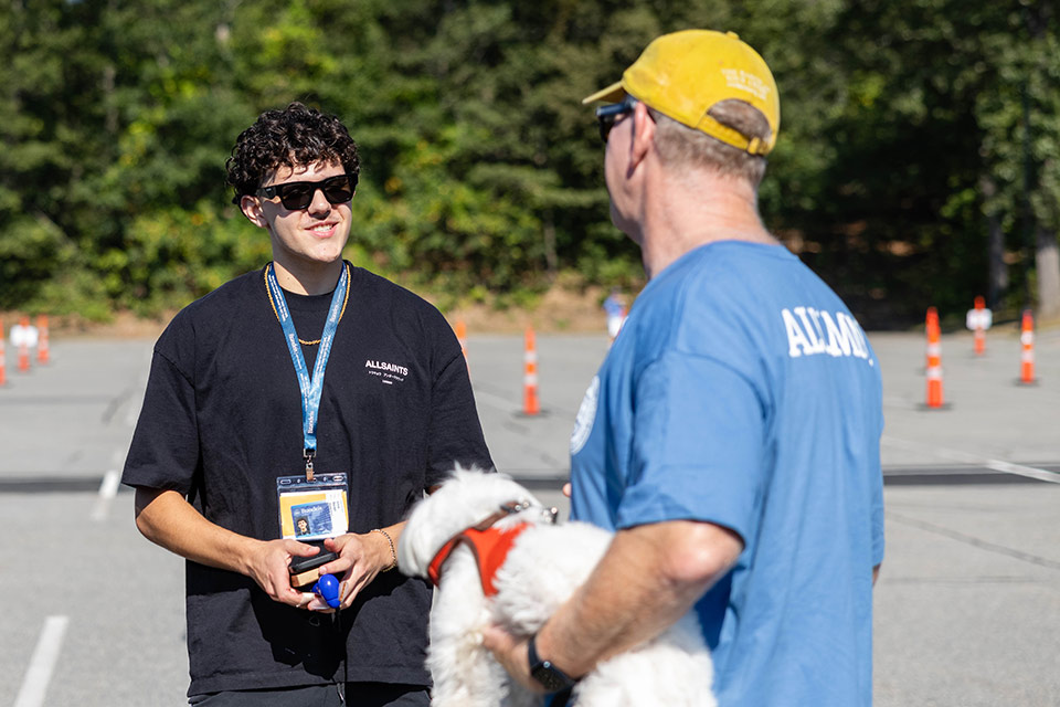 First-year student Emre B. ’29 speaks to Brandeis alum Sidney Levinson.