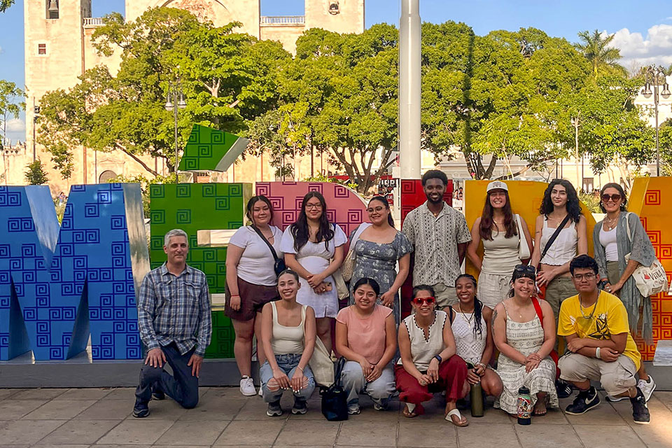 Samuel Hadego stands with a group of people in front of a Merida sign.